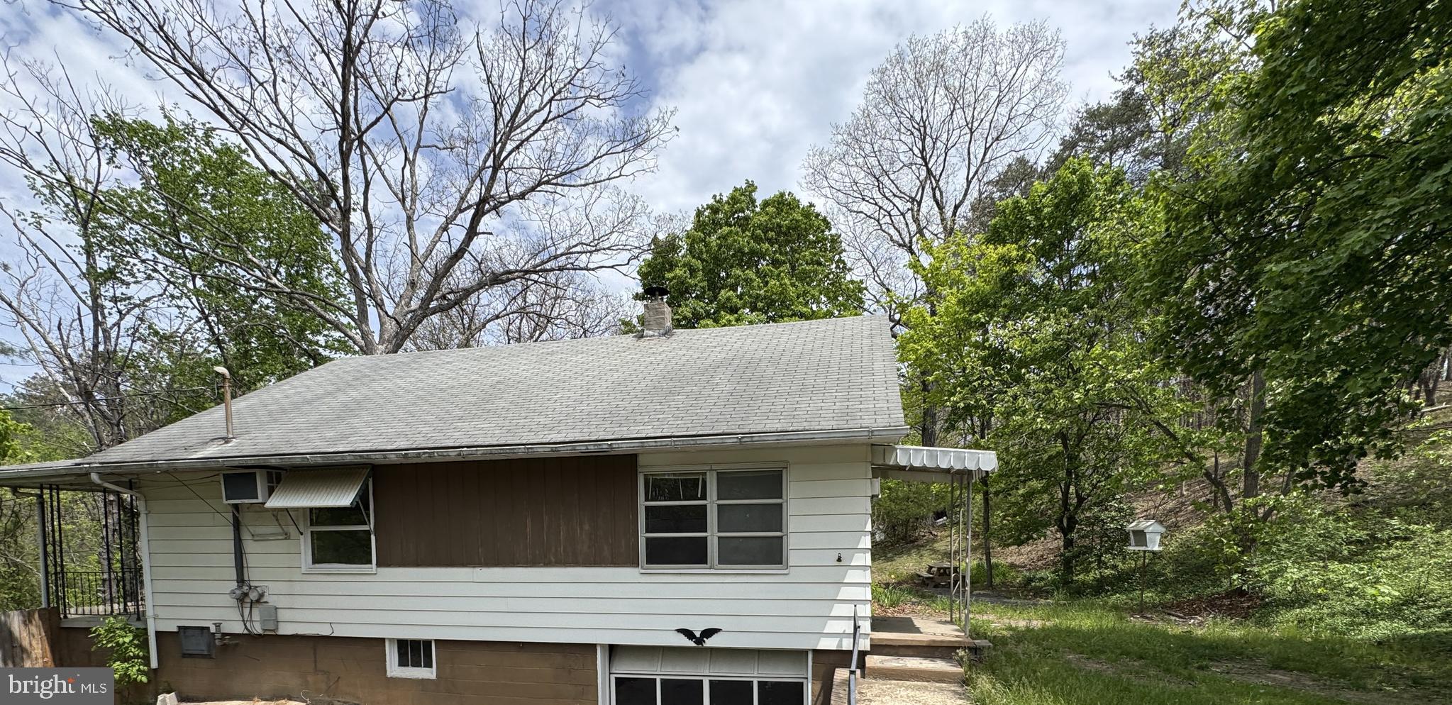85 Ralph Barnes Lane Fort Ashby, WV 26719 - Photo 3 of 15 a house that has tree in front of it