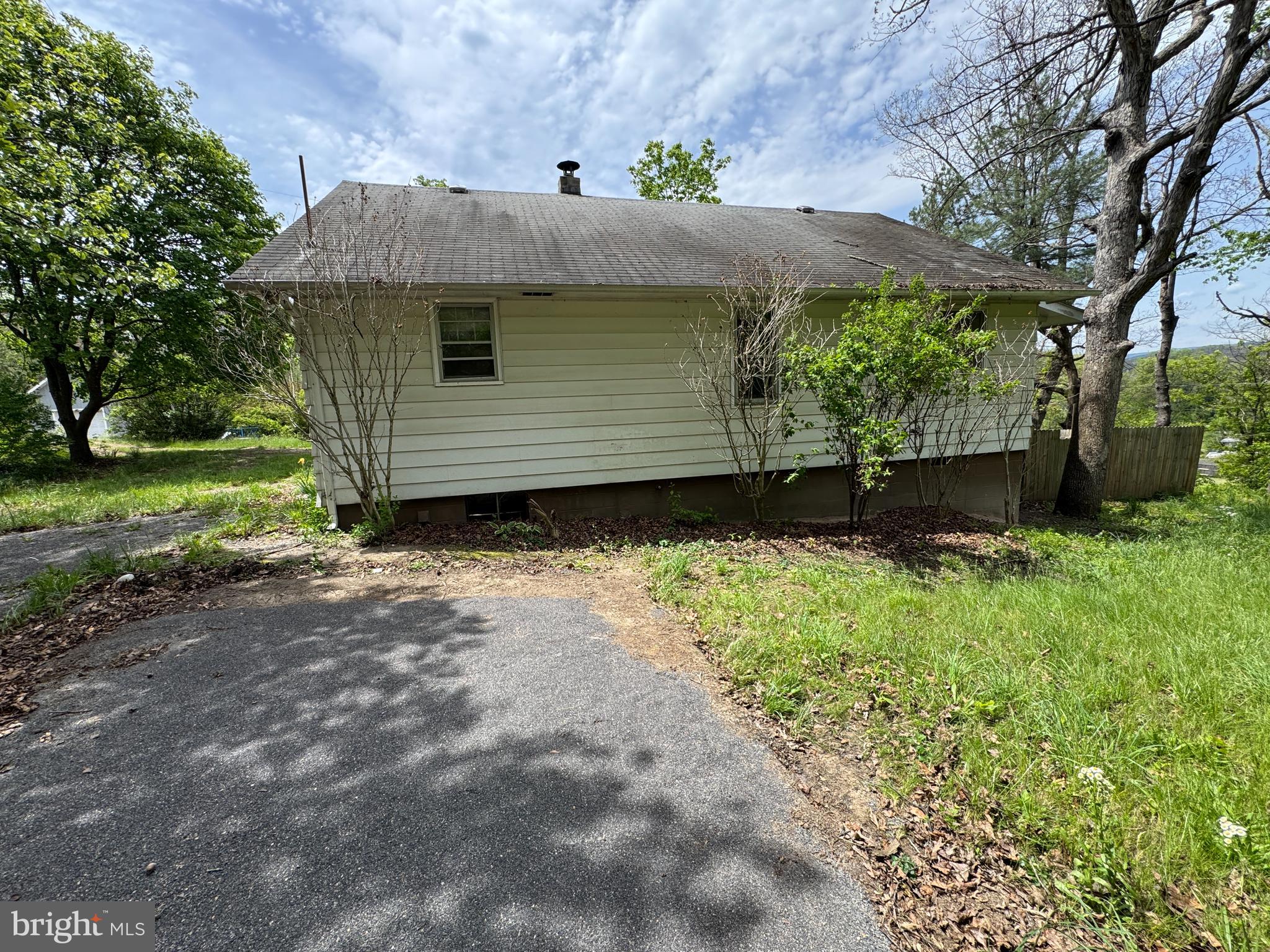 85 Ralph Barnes Lane Fort Ashby, WV 26719 - Photo 4 of 15 a front view of a house with garden