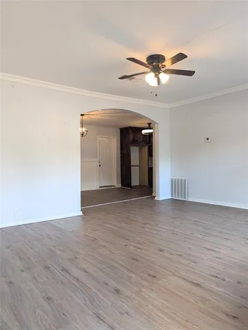 a view of a livingroom with a ceiling fan and window