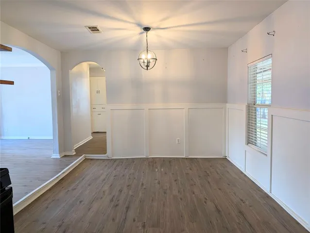 a view of a room with wooden floor and white walls