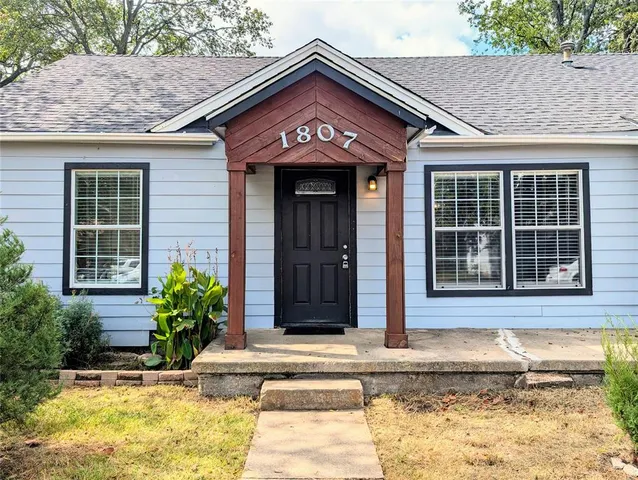 a view of a brick house with plants