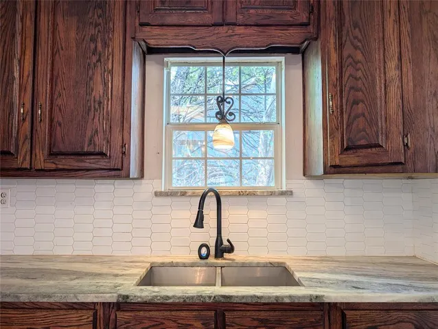 a kitchen with a sink and cabinets
