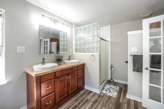 a white bath tub sitting in a bathroom next to a window