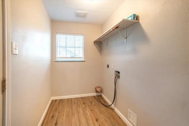 a view of a room with wooden floor and windows