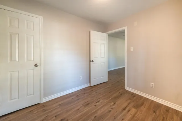 an empty room with wooden floor