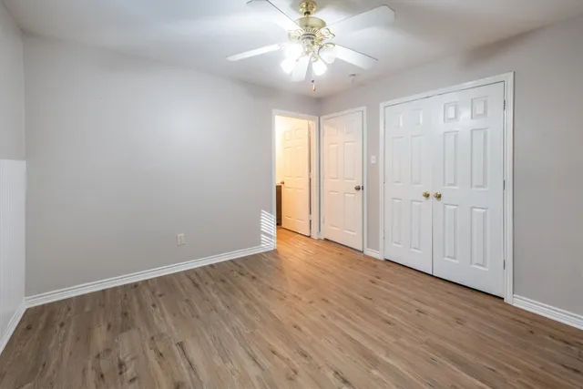 a view of an empty room with wooden floor