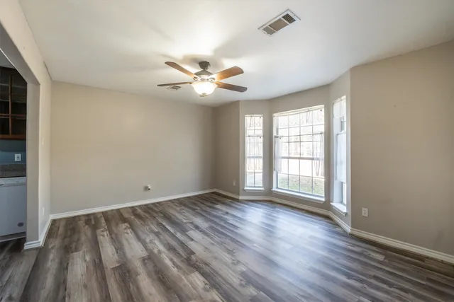 a view of a hallway view with living room and wooden floor