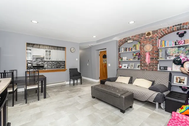 a living room with furniture and a book shelf