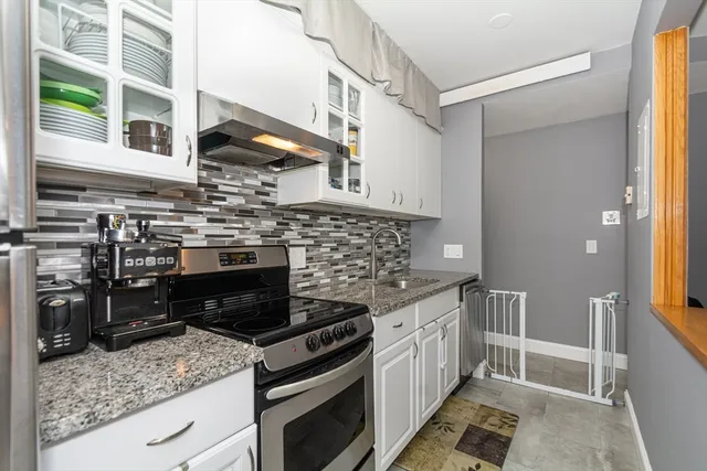a kitchen with stainless steel appliances granite countertop a stove and a sink
