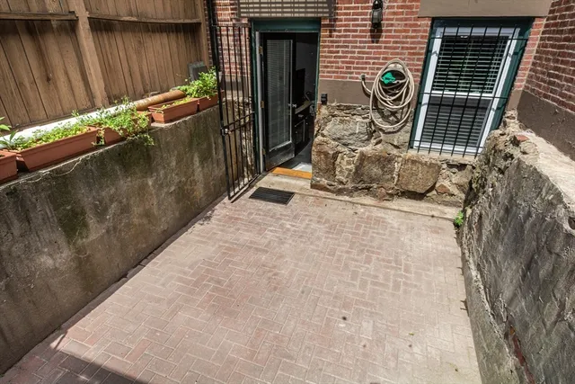 a backyard of a house with table and chairs