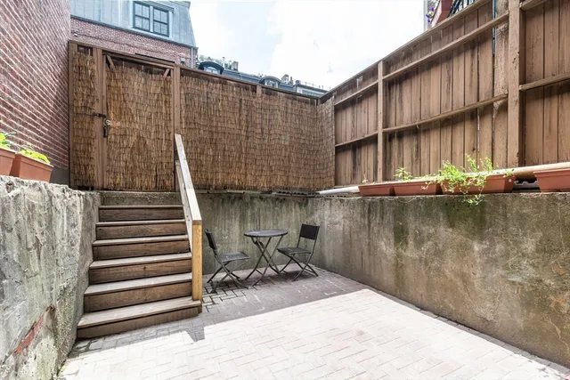 a backyard of a house with wooden deck