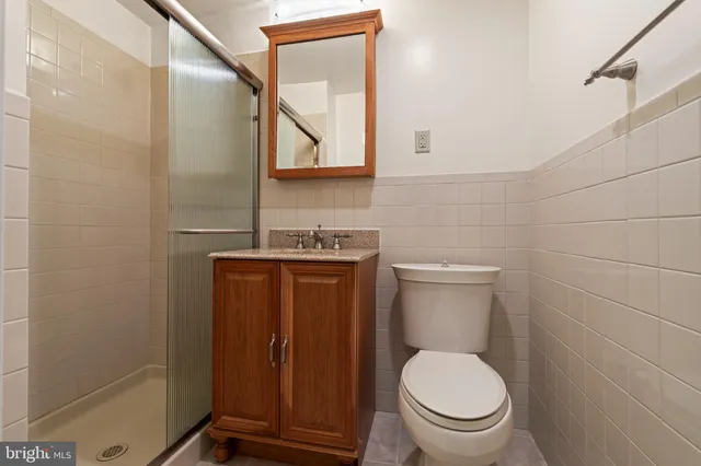 a bathroom with a toilet a sink and mirror