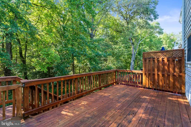 a balcony with wooden floor and fence