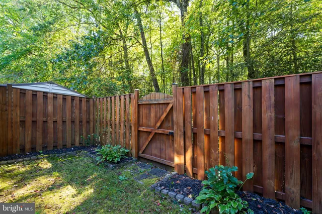 a view of a backyard with wooden fence