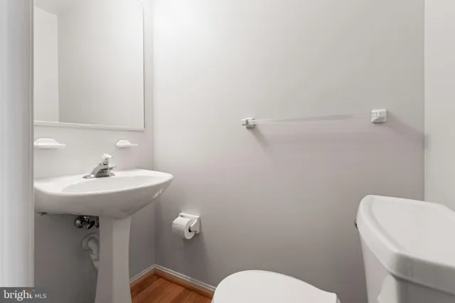 a bathroom with a sink a toilet and mirror