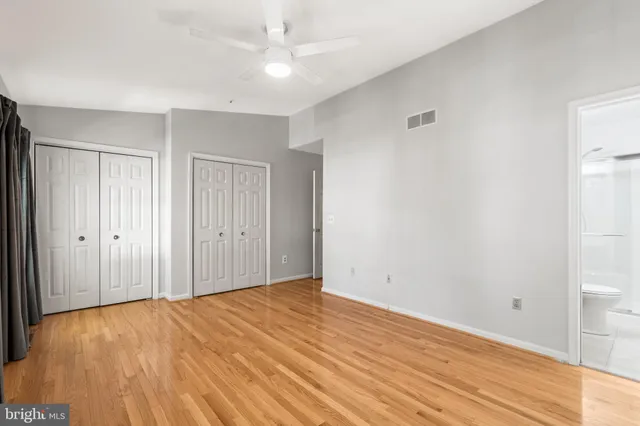 a view of an empty room and wooden floor