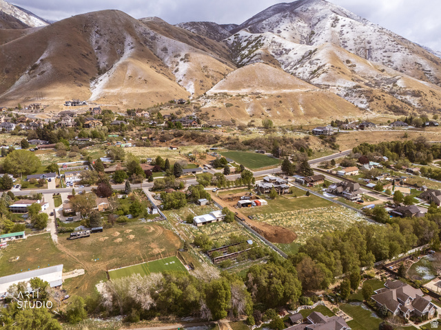 2672 East Canyon Road Springville, UT 84663 - Photo 16 of 33 Aerial view of residential area featuring a mountain backdrop