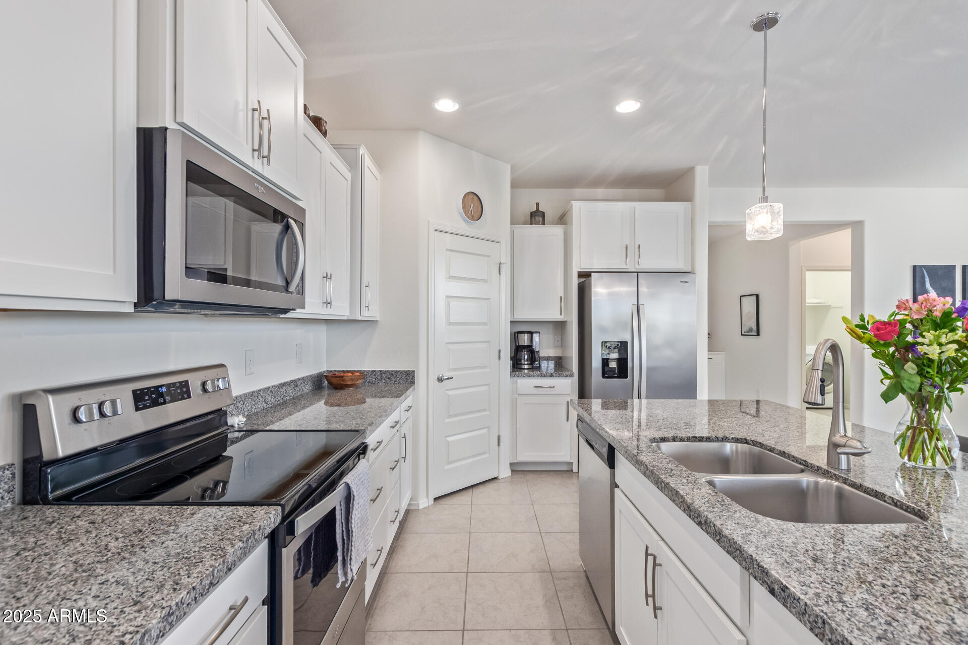 17796 West Sandy Road Goodyear, AZ 85338 - Photo 15 of 68 a kitchen with stainless steel appliances granite countertop a sink stove and refrigerator