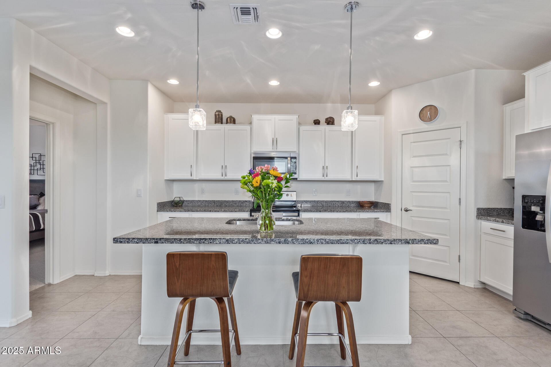 17796 West Sandy Road Goodyear, AZ 85338 - Photo 17 of 68 a kitchen with kitchen island granite countertop a table and chairs in it