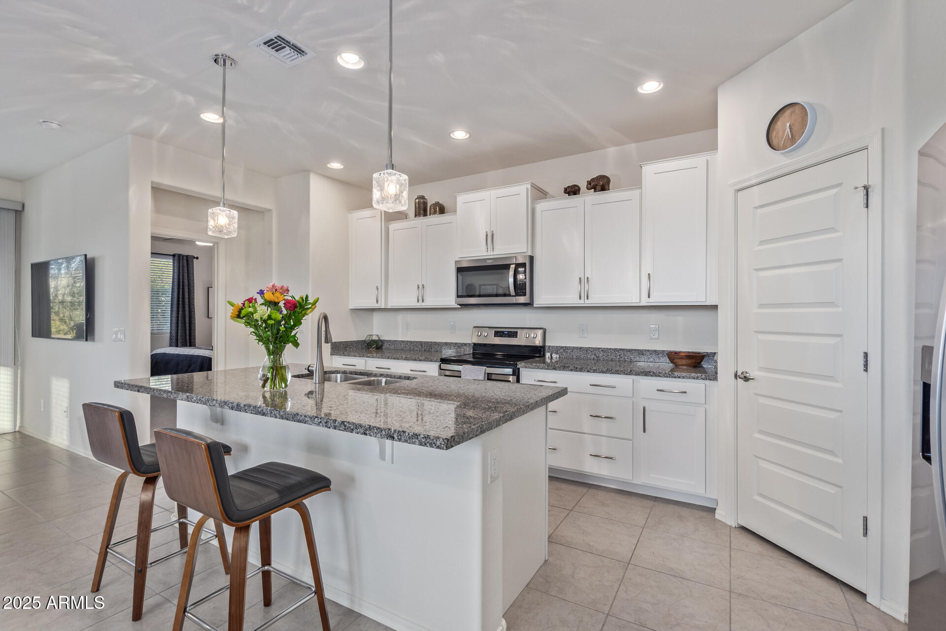 17796 West Sandy Road Goodyear, AZ 85338 - Photo 18 of 68 a kitchen with kitchen island granite countertop appliances cabinets and chairs
