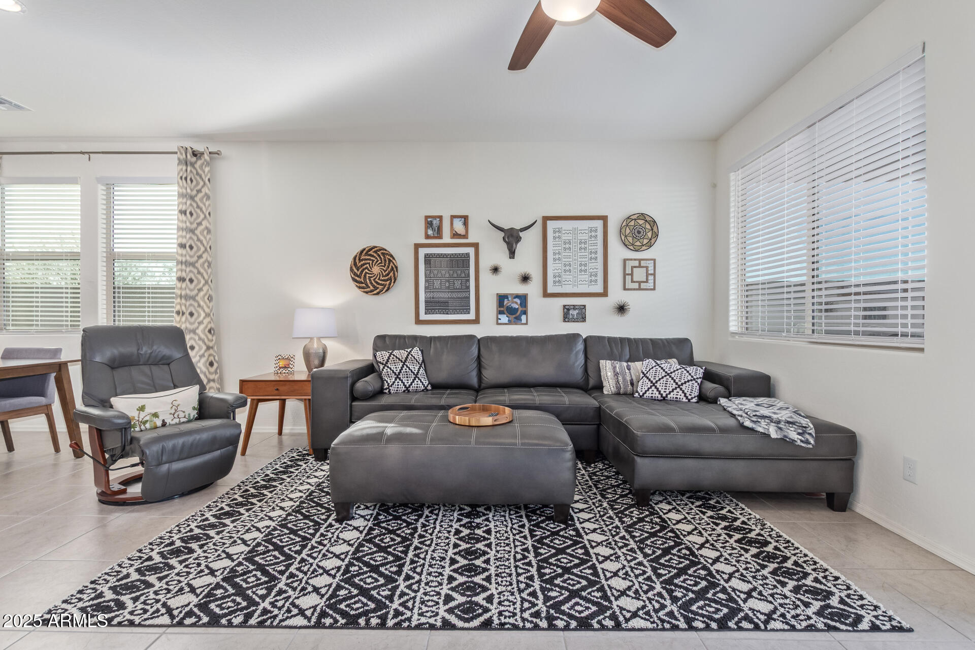 17796 West Sandy Road Goodyear, AZ 85338 - Photo 19 of 68 a living room with furniture ceiling fan and a window