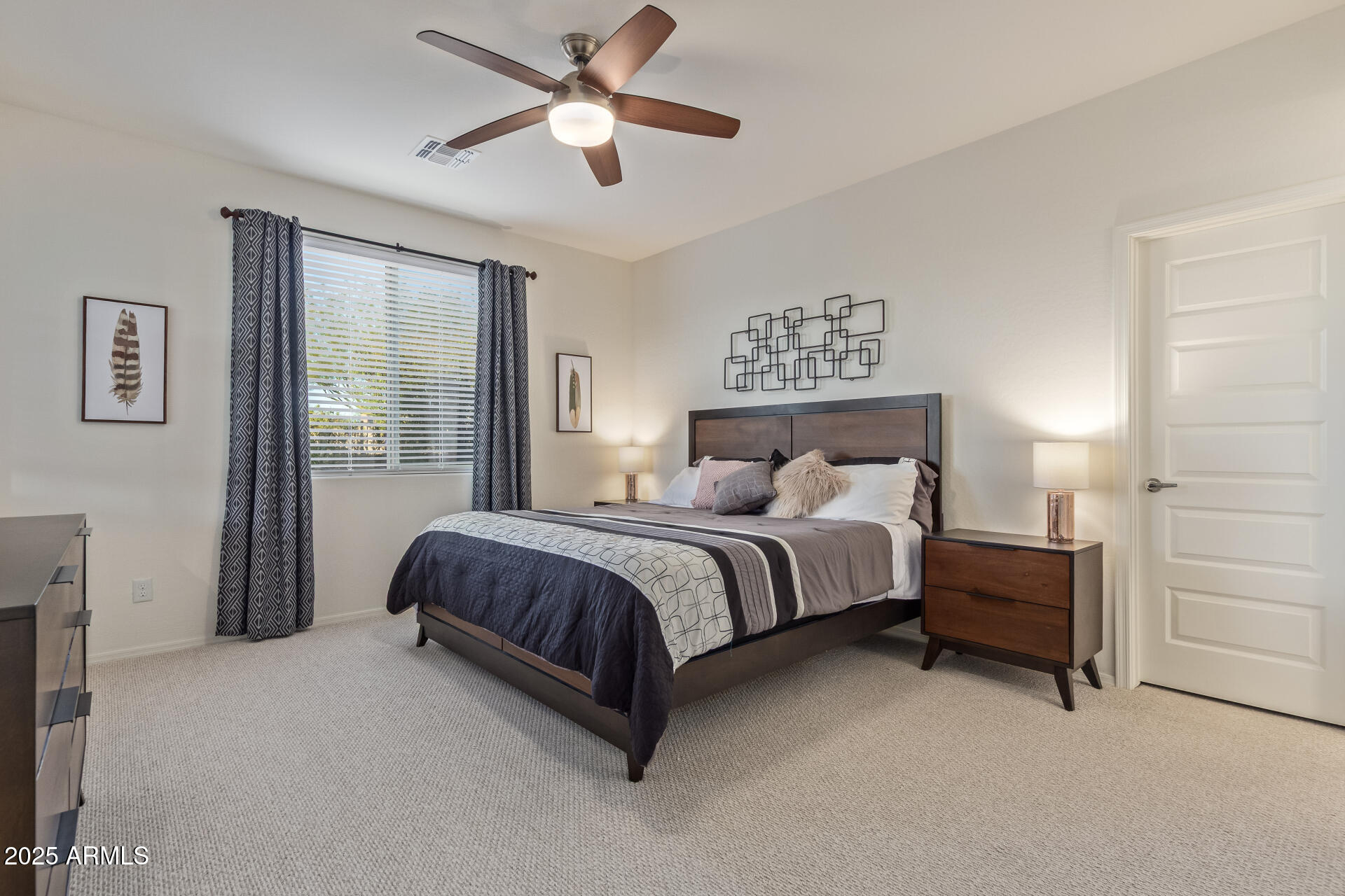 17796 West Sandy Road Goodyear, AZ 85338 - Photo 22 of 68 a spacious bedroom with a bed and a window