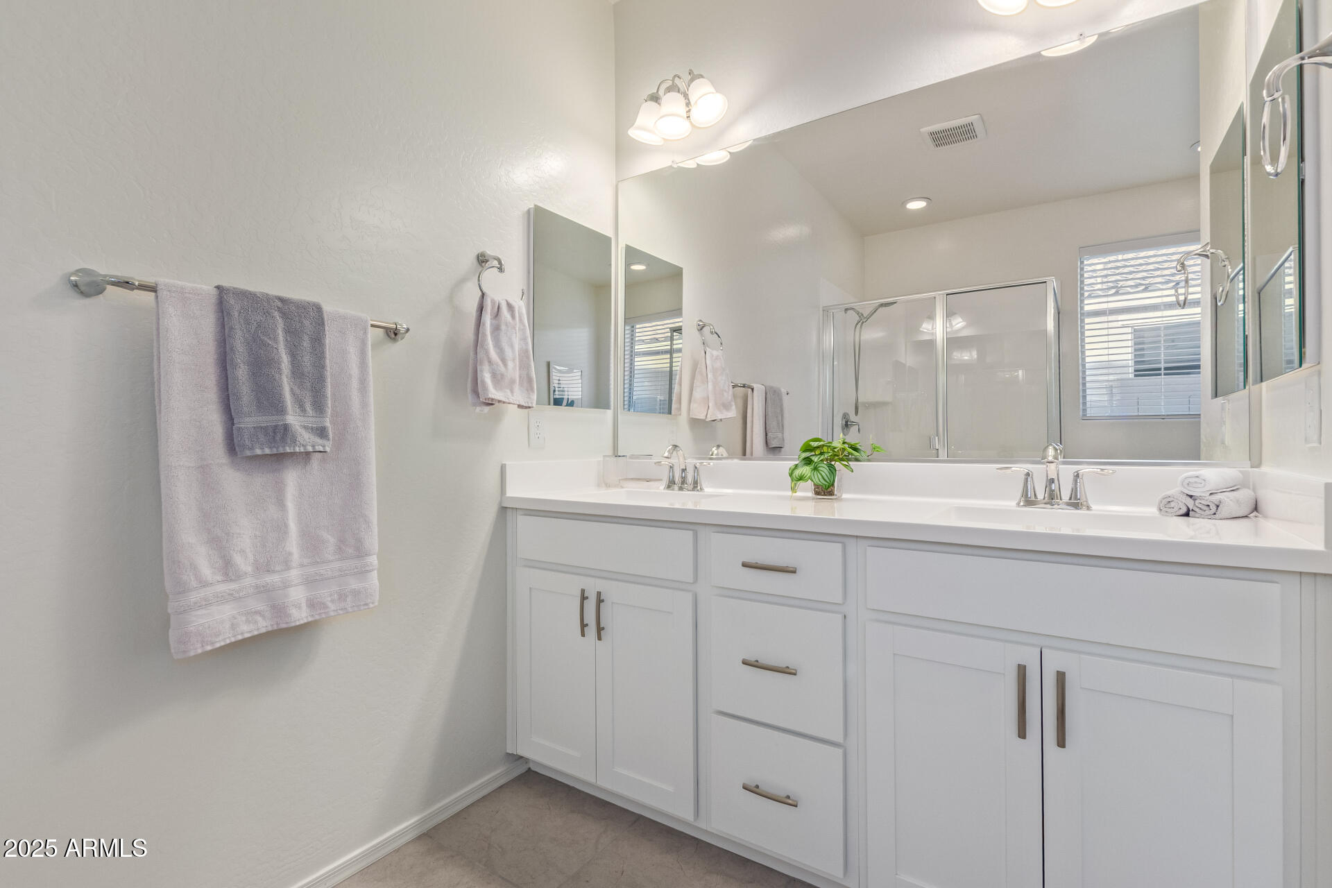 17796 West Sandy Road Goodyear, AZ 85338 - Photo 24 of 68 a bathroom with double sink and a mirror