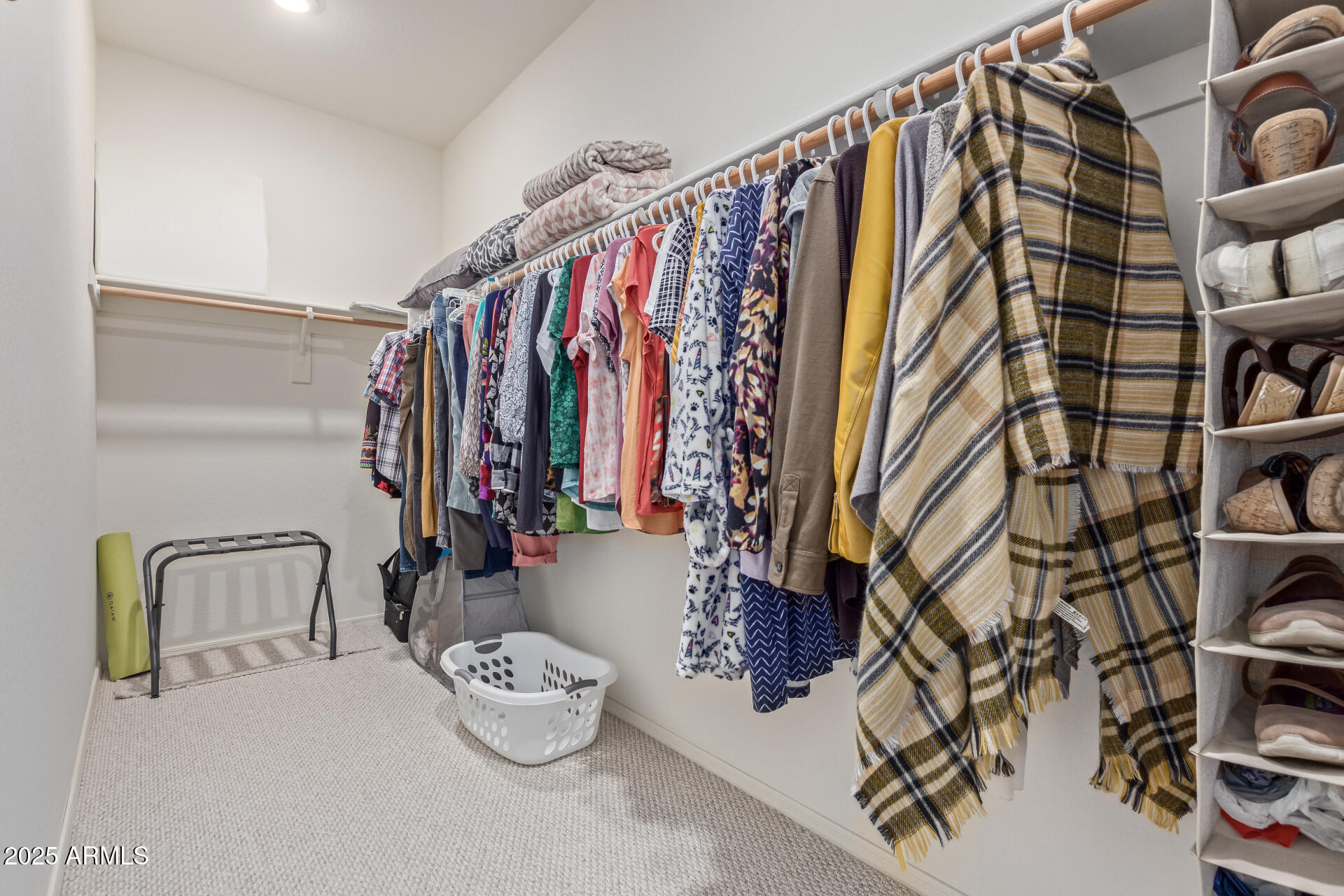 17796 West Sandy Road Goodyear, AZ 85338 - Photo 26 of 68 a view of walk in closet with clothes and shoes