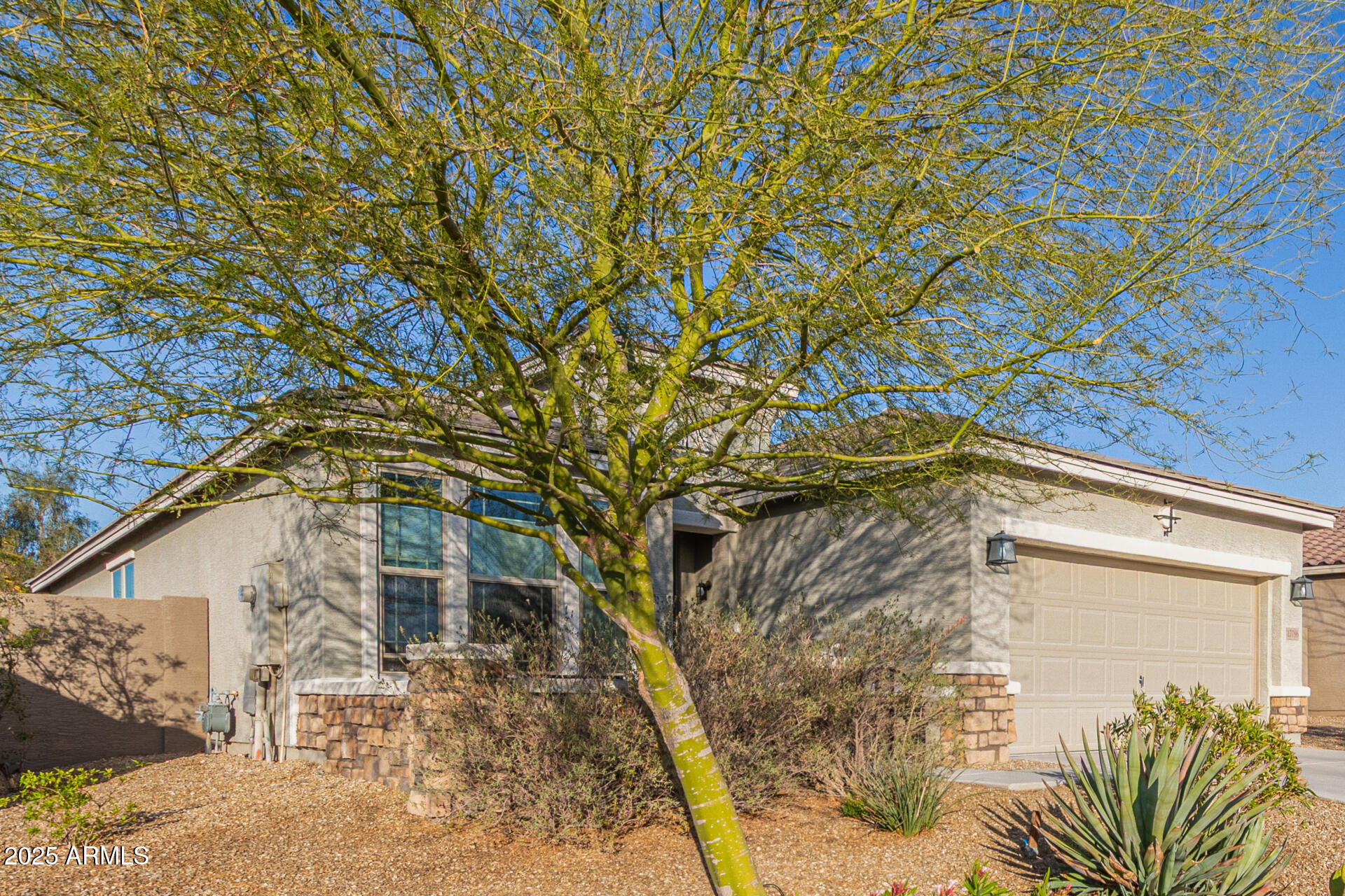 17796 West Sandy Road Goodyear, AZ 85338 - Photo 52 of 68 a yellow house with trees in front of it