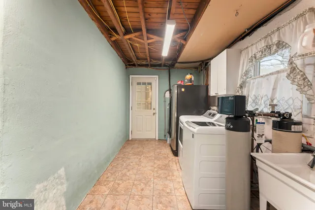 a view of a storage & utility room with a sink
