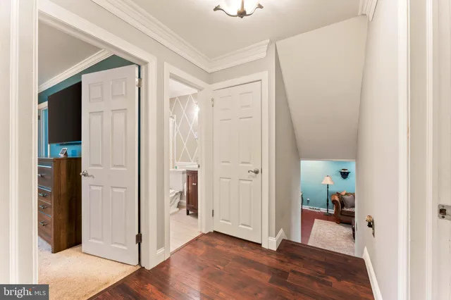 a view of a hallway view with wooden floor and staircase