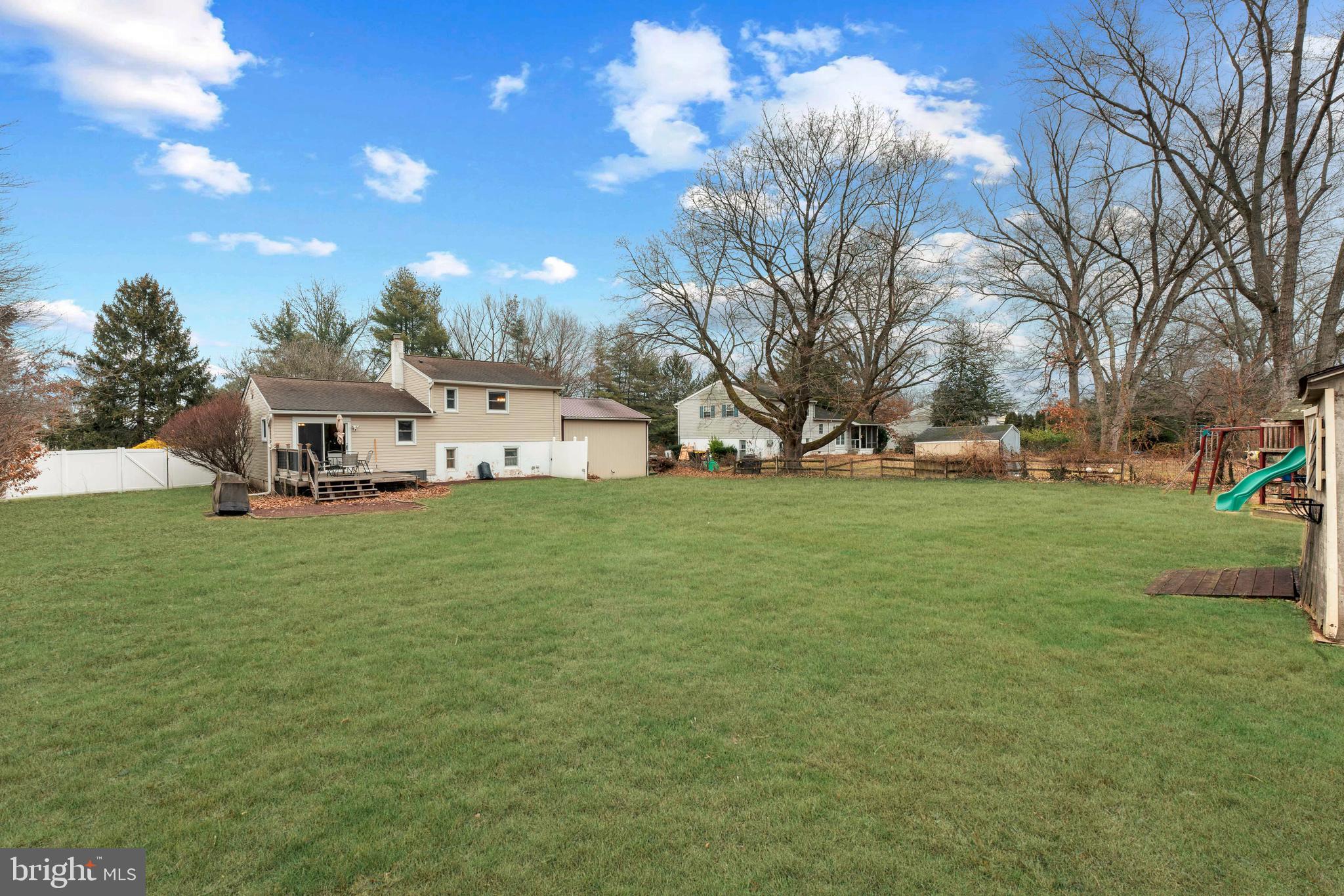 992 Jamison Street Warminster, PA 18974 - Photo 34 of 37 a view of a white house in front of a big yard with plants and large trees