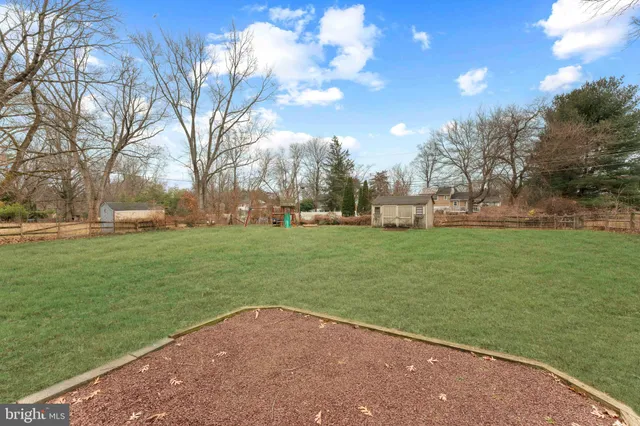 a view of a patio with a table chairs and a yard