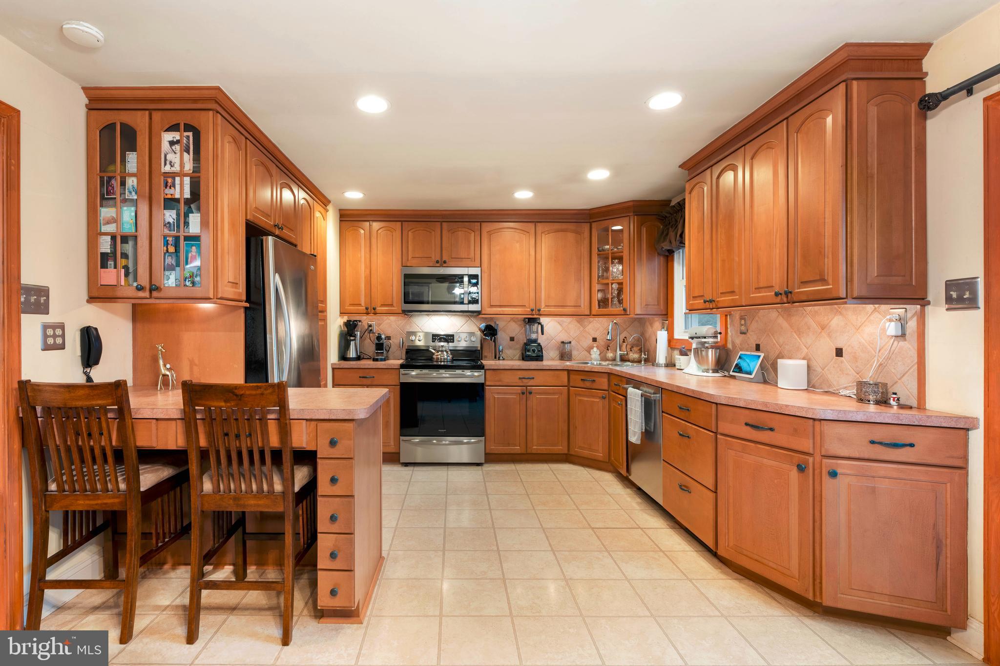 992 Jamison Street Warminster, PA 18974 - Photo 9 of 37 a kitchen with stainless steel appliances granite countertop wooden cabinets a refrigerator top oven a sink and dishwasher
