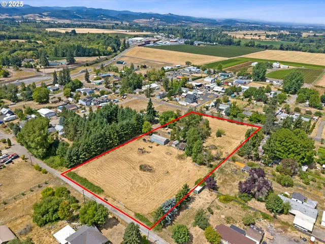 an aerial view of lake and residential houses with outdoor space
