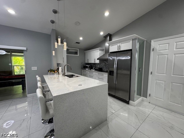 8409 Tahiti Road, Unit A Fort Myers, FL 33967 - Photo 7 of 23 a kitchen with stainless steel appliances a refrigerator and a sink