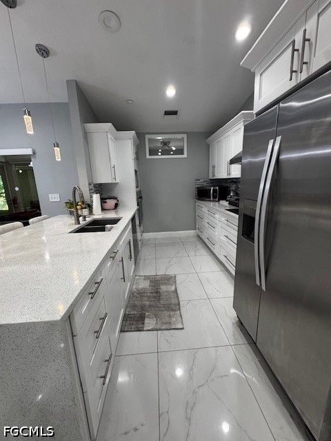 8409 Tahiti Road, Unit A Fort Myers, FL 33967 - Photo 9 of 23 a kitchen with stainless steel appliances a sink a stove a refrigerator and cabinets