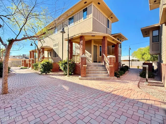 a view of a building with cars parked on the road