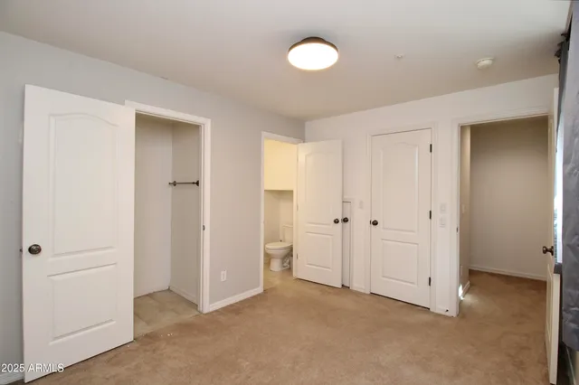 a view of an empty room with closet area