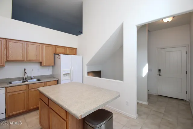 a kitchen with a sink a stove and refrigerator