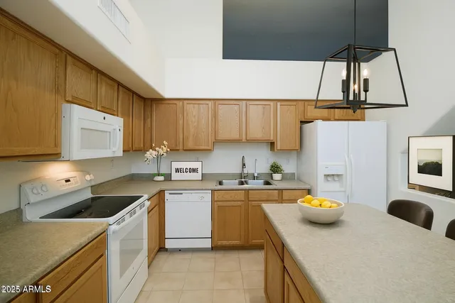 a kitchen with a sink a stove and cabinets