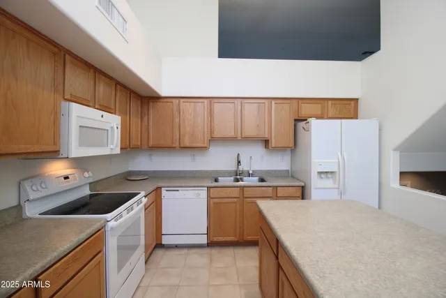 a kitchen with a sink a stove and cabinets