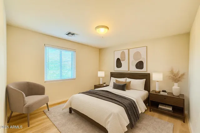 a bedroom with a bed and wooden floor