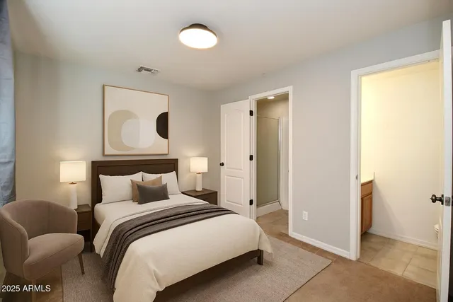 a bedroom with a bed and a painting on the wall