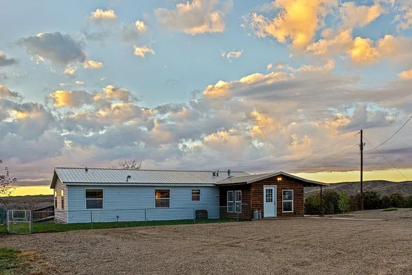 a view of a house next to a yard