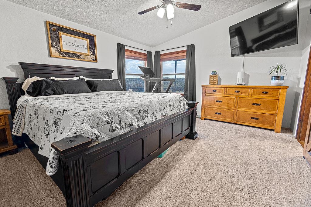 6181 Highway 394 Craig, CO 81625 - Photo 5 of 15 a bedroom with a bed and flat tv screen on the dresser