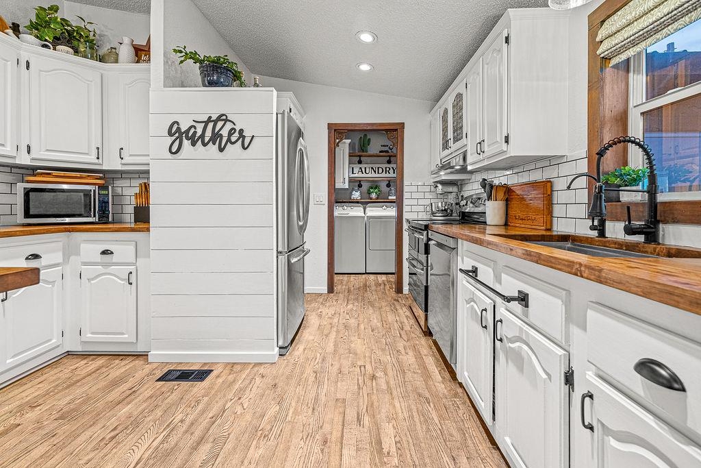 6181 Highway 394 Craig, CO 81625 - Photo 10 of 15 a kitchen with granite countertop white cabinets and stainless steel appliances