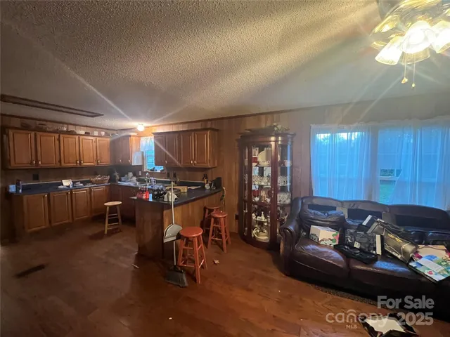 a living room with lots of furniture and a large window