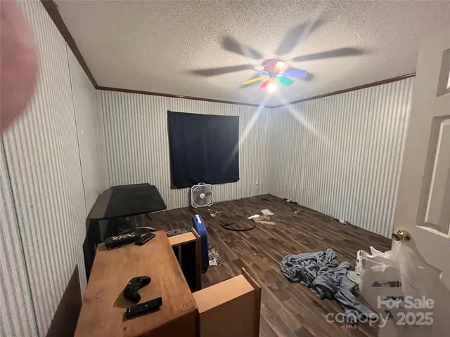 a living room with rug floor and a flat screen tv