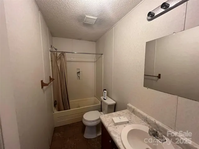 a white toilet sitting next to a bathroom sink and a shower